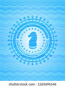chess knight icon inside water wave badge.