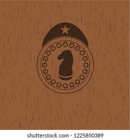 chess knight icon inside wooden emblem. Vintage.