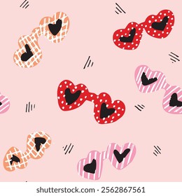 Chic glasses in heart shape with cute little dots, checks and stripes printed frames in a vibrant color palette of red, pink, black and orange over pink background. A seamless vector pattern. 
