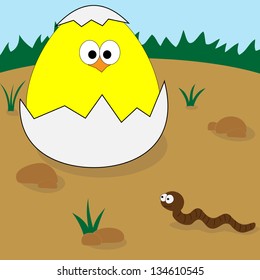 Chick in eggshell looks at crawling worm