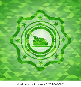 chicken dish icon inside green emblem with mosaic background
