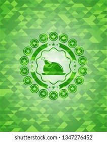 chicken dish icon inside green mosaic emblem