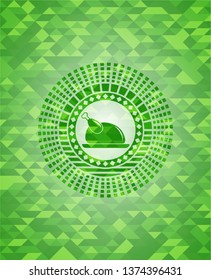 chicken dish icon inside green emblem with triangle mosaic background