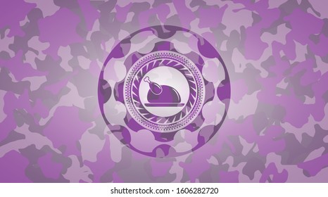 chicken dish icon inside pink camouflage emblem