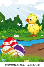 Chicken and Easter eggs near the creek on a green spring meadow. Easter scene