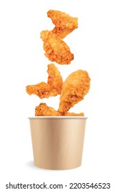 Chicken fast food realistic composition with isolated view of fried chicken wings falling into paper bucket vector illustration