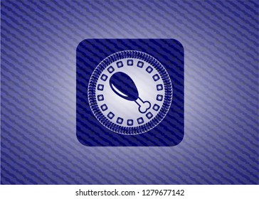 chicken leg icon inside emblem with denim texture