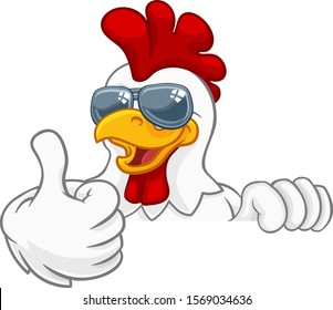 A chicken rooster cockerel bird cartoon character in cool shades or sunglasses peeking over a sign and giving a thumbs up