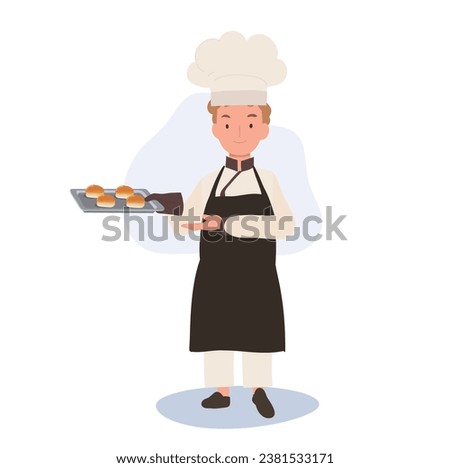 Child Cook in Chef's Hat and Apron Baking a Delicious Bun. Kid Chef Proudly Presents Fresh Homemade Baked Bun
