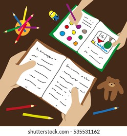 The child draws, dad/teacher reads him a book. View from above.