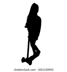 The child drives a kick scooter. Silhouette