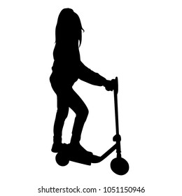 The child drives a kick scooter. Silhouette