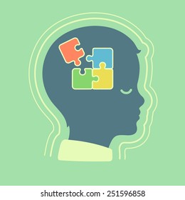 child head profile silhouette with jigsaw puzzle symbolizing autism spectrum disorders