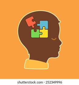 child head profile silhouette with jigsaw puzzle symbolizing autism spectrum disorders