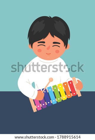 Child playing xylophone on the table. Kids' wooden musical instrument. Children musical and creativity development concept. 