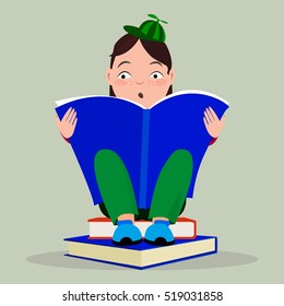 The child reads. Boy reads. little boy reading a book. little boy in a cap with propellerom reading a book