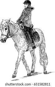A child is riding a horse