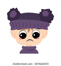 Child with sad emotions, depressed face, down eyes in violet hat with pom pom. Head of toddler with melancholy expression