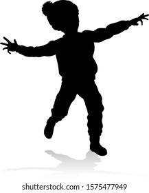 A child in silhouette playing in Christmas or winter cold weather clothing