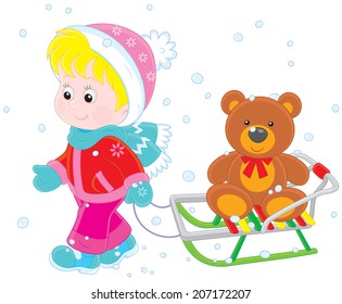 Child with a sled and toy bear