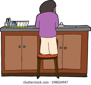 Child standing on chair washing dishes at sink