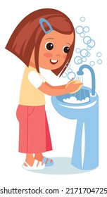 Child washing hand in sink with soap bubbles around
