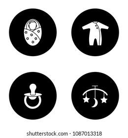 Childcare glyph icons set. Swaddled baby, romper, pacifier, bed carousel. Vector white silhouettes illustrations in black circles