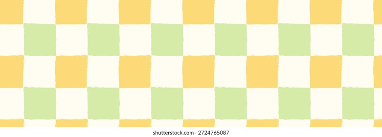 Childish checkered pattern on yellow and green. Fresh spring background. Cute baby seamless print. Pastel color