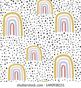 Childish seamless pattern with hand drawn rainbow and dots. Trendy kids vector background.