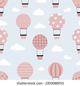 Childish seamless pattern with hot air balloons in sky. Hand drawn airship. Pink and blue colors. Vector illustration.