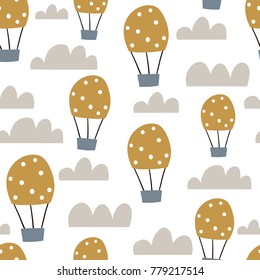 Childish seamless pattern with hot air ballon in the sky. Cute cartoon background. Perfect for fabric, textile, wrapping.Vector Illustration