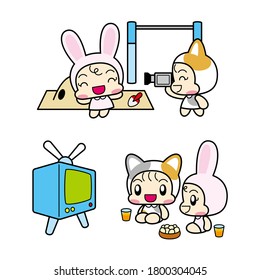 children in cat and rabbit costumes playing with video camera and television