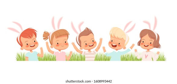 Children dressed in bunnies laugh and wave their hands in the grass. Children congratulate you on Easter.