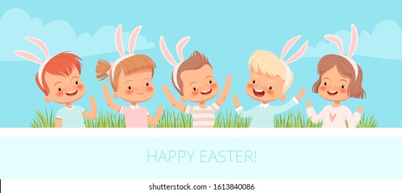Children dressed in bunnies laugh and wave their hands in the grass. Children congratulate you on Easter.