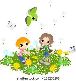 Children flying seeds in the field where the dandelion blooms.