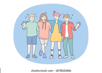 Children, friendship, happiness concept. Group of smiling cheerful children friends standing, hugging and waving hands together during walk or party celebration. Fun leisure recreation for children 