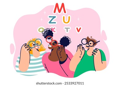 Children with glasses on eyes read letters to test vision and new lenses recommended by optometrist. Little girls and boy rejoice at receiving glasses to get rid of nearsightedness or farsightedness