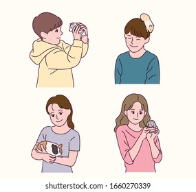 The children are looking at the cute hamster with their hands on it. hand drawn style vector design illustrations. 