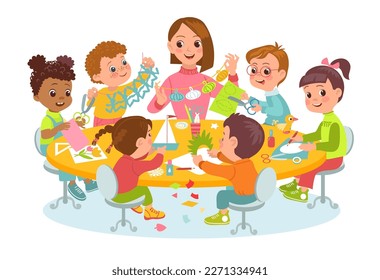 Children make paper crafts with teacher. Joint creativity. Students group at table. Kids carve figurines. Boys and girls cut and fold pages. Kindergarten lesson. Splendid