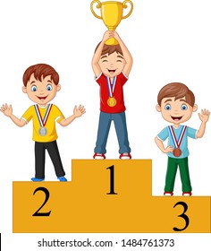 Children with medals standing on podium and holding a trophy