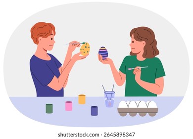 Children paint easter eggs in preparation for main christian holiday, standing at table with gouache and brushes. Celebrations easter in orthodox and catholic culture, on day of resurrection jesus