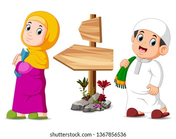 the children are posing near the wooden signpost