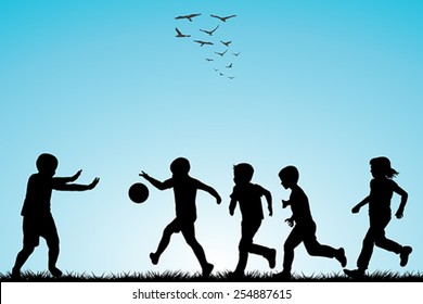 Children silhouettes playing football