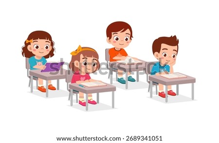 Children studying in classroom sitting at desks reading books in elementary school