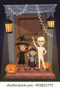 Children in vampire costumes, witches and mummies stand on threshold of the house on the Halloween night.