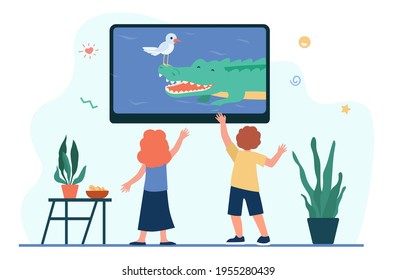 Children watching television in living room. Kids enjoying program on TV about wildlife flat vector illustration. Indoor activity, leisure concept for banner, website design or landing web page