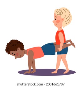 Childrenes sports gymnastics. A boy is holding the legs of another boy. Pair exercises for the hands.