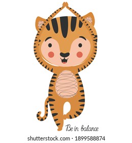 Children's cartoon illustration of a cute little joyful tiger cub in yoga asana Vrikshasana tree pose and handwritten "Be in balance" lettering on white background. Sporty ginger cat. Vector.