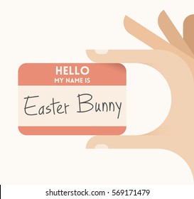 Children's hand holding card with text Hello my name is Easter Bunny. Idea - Easter holiday celebration concept.