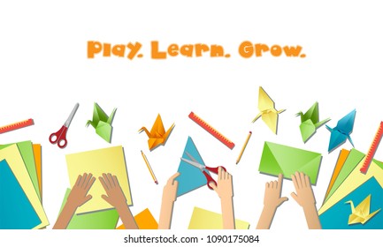 Children's hands do origami from colored paper on white background. lesson of origami